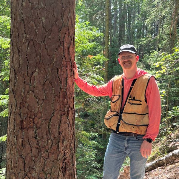 Matt Wawrzyniak in the woods, wearing a cruiser vest